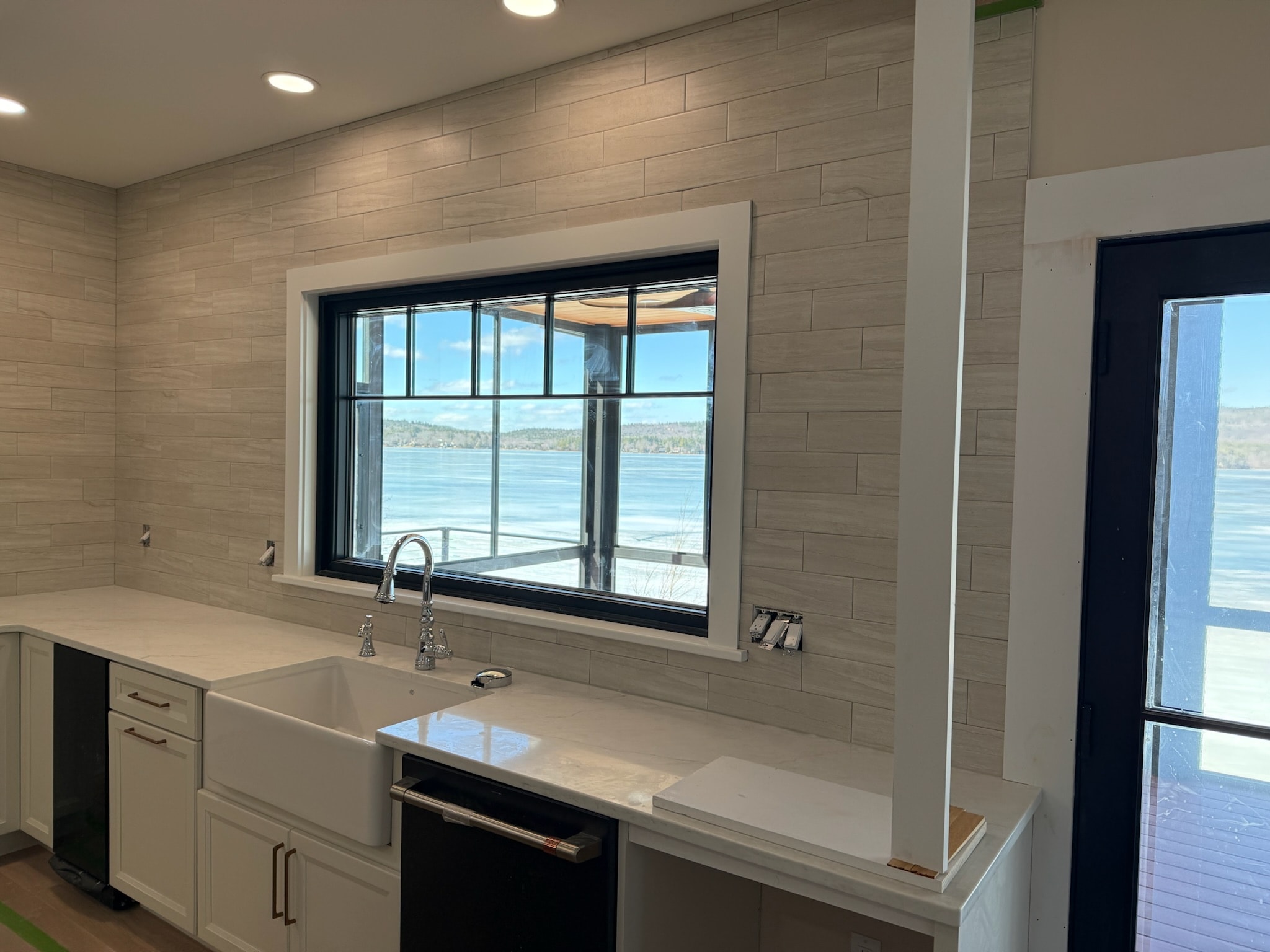 Large-format tile wall with lake view