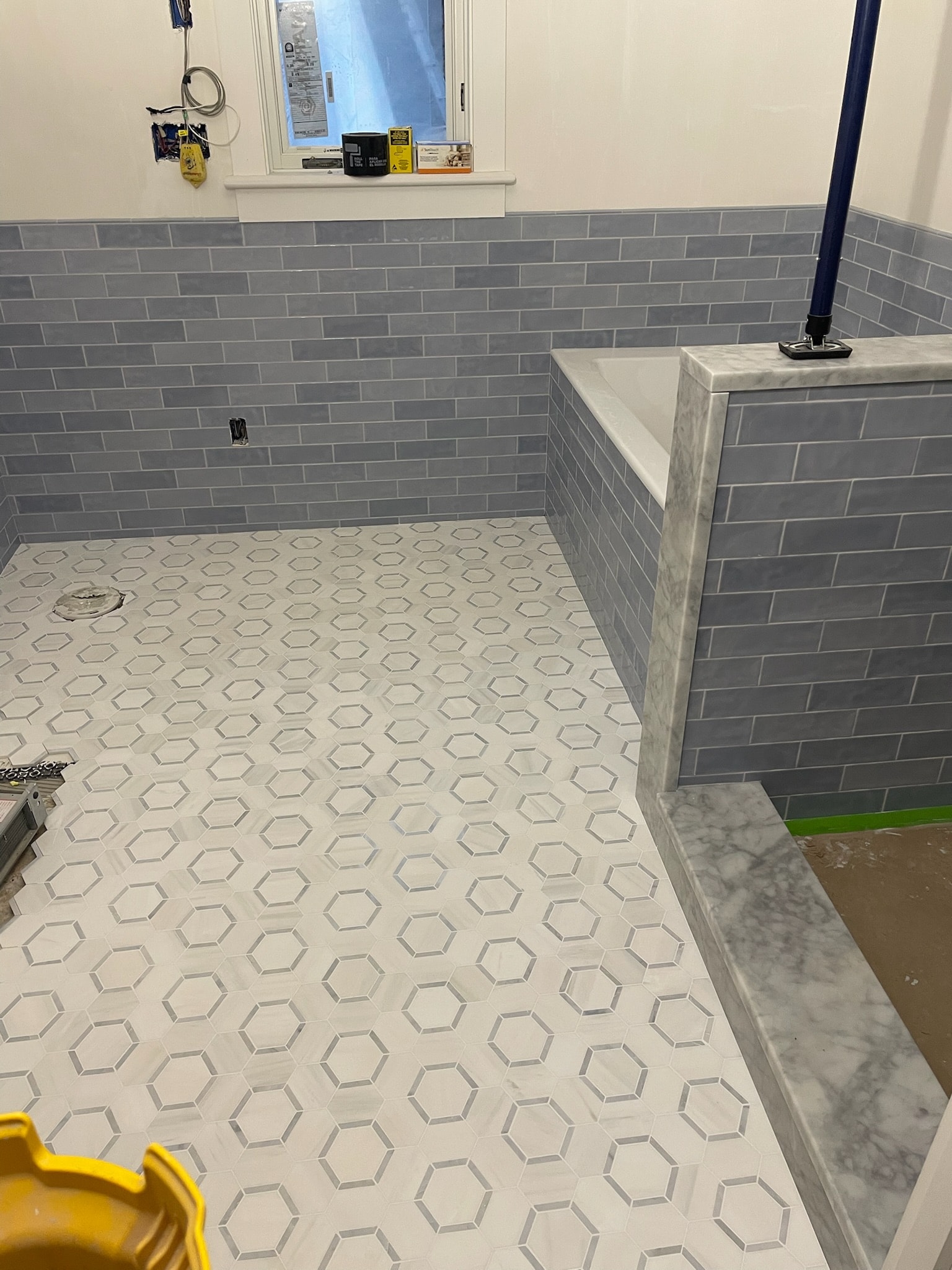 Hexagon mosaic floor with marble bench surround